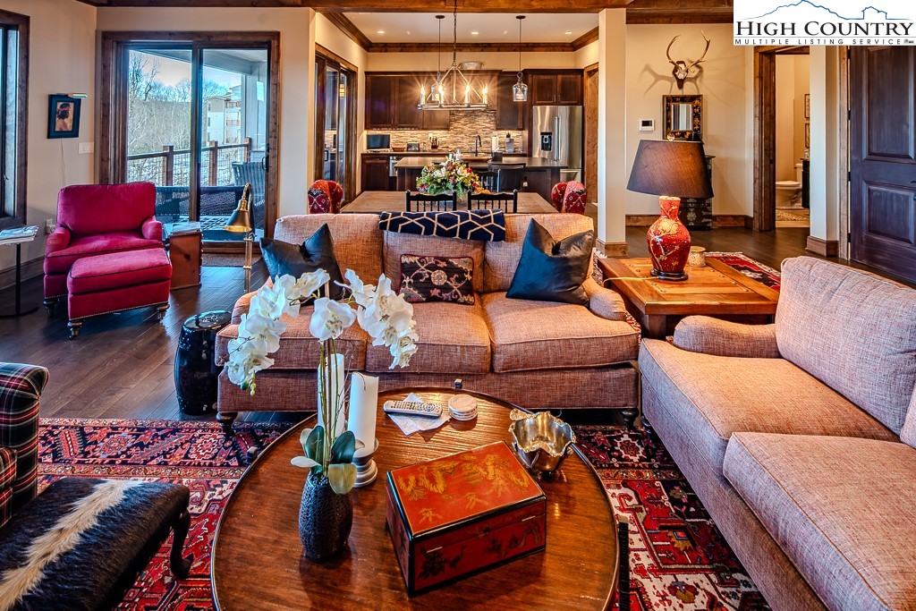 215 Cone Vista Circle, Unit B Blowing Rock, NC 28605 - Photo 8 of 50 a living room with furniture and a chandelier