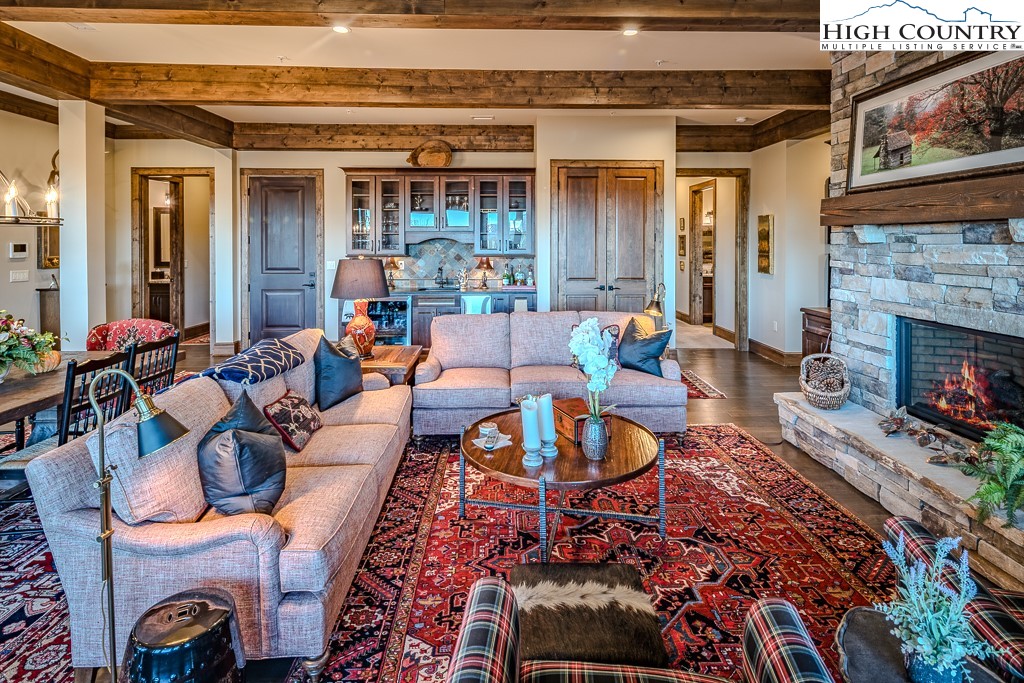 215 Cone Vista Circle, Unit B Blowing Rock, NC 28605 - Photo 10 of 50 a living room with furniture a fireplace and wooden floor