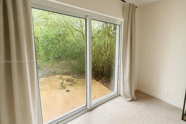 a view of a glass door with a glass door and a porch