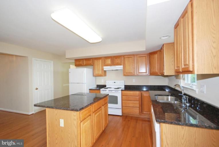 5976 Florey Road Hanover, MD 21076 - Photo 28 of 30 a kitchen with a sink a counter top space and cabinets