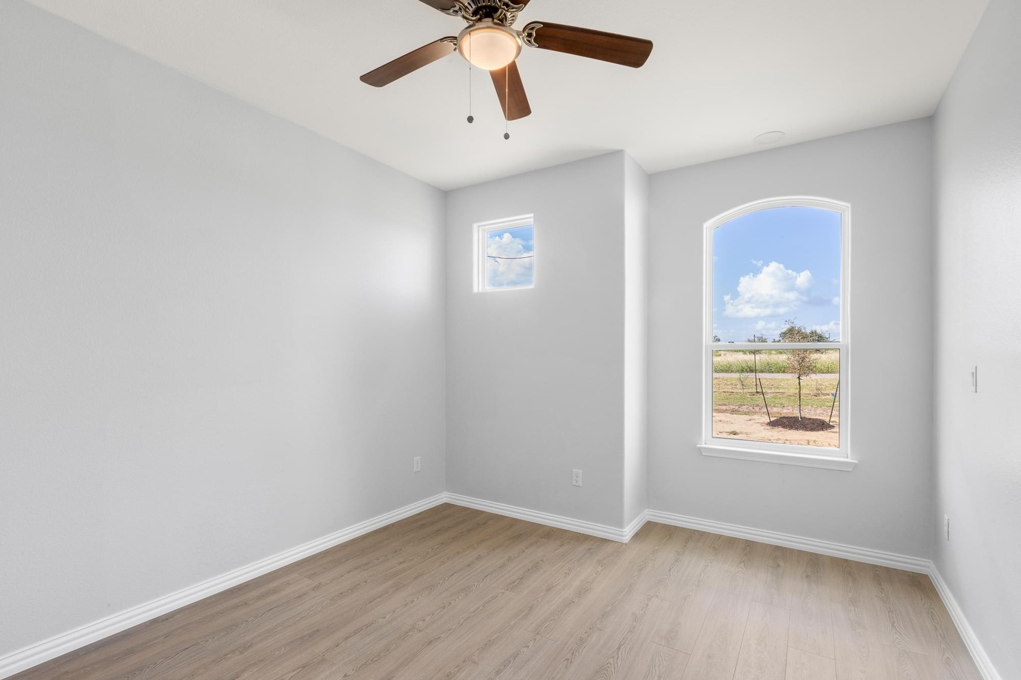 1136 County Road 484 Elgin, TX 78621 - Photo 24 of 37 Unfurnished room with light wood-style flooring and a ceiling fan
