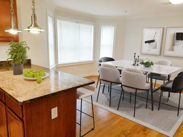a dining room with furniture and wooden floor