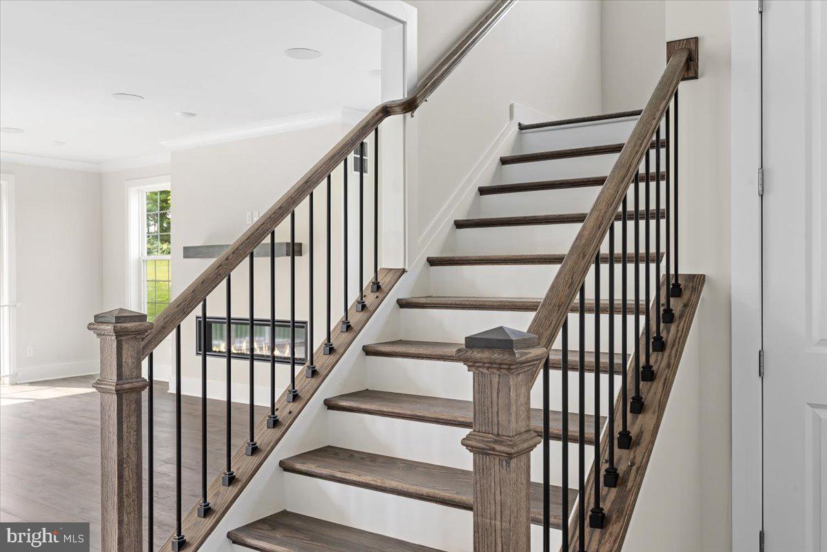 3900 Logmill Road Gainesville, VA 20155 - Photo 15 of 47 Iron balusters, stained hardwood staircase
