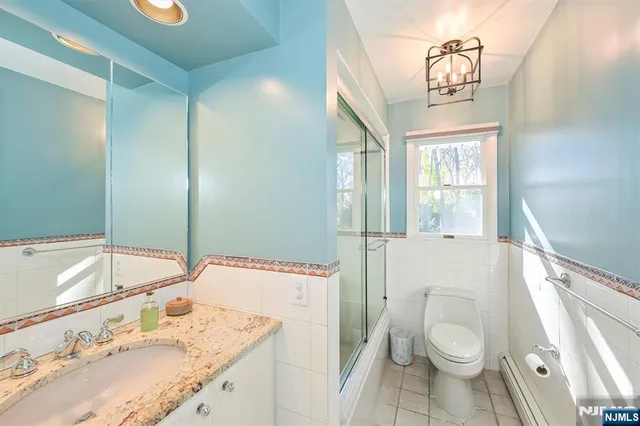 a view of a patio with table and chairs with wooden floor and fence