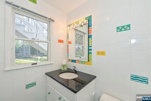 a view of swimming pool with lawn chairs and large trees