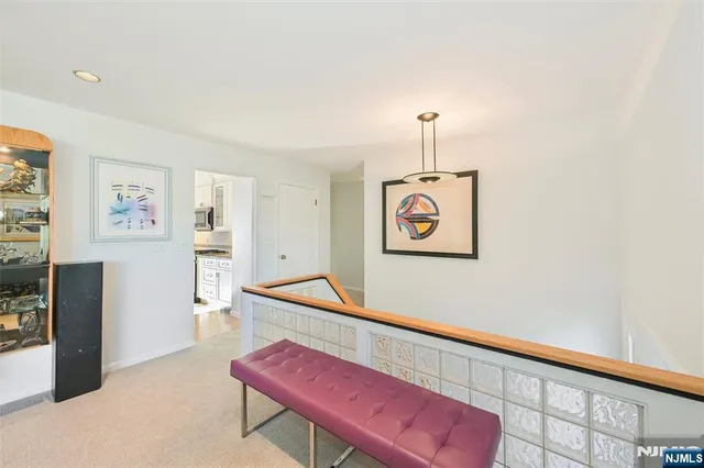 a living room with furniture and kitchen view