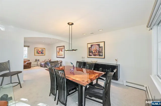 a bedroom with a bed wooden floor and window