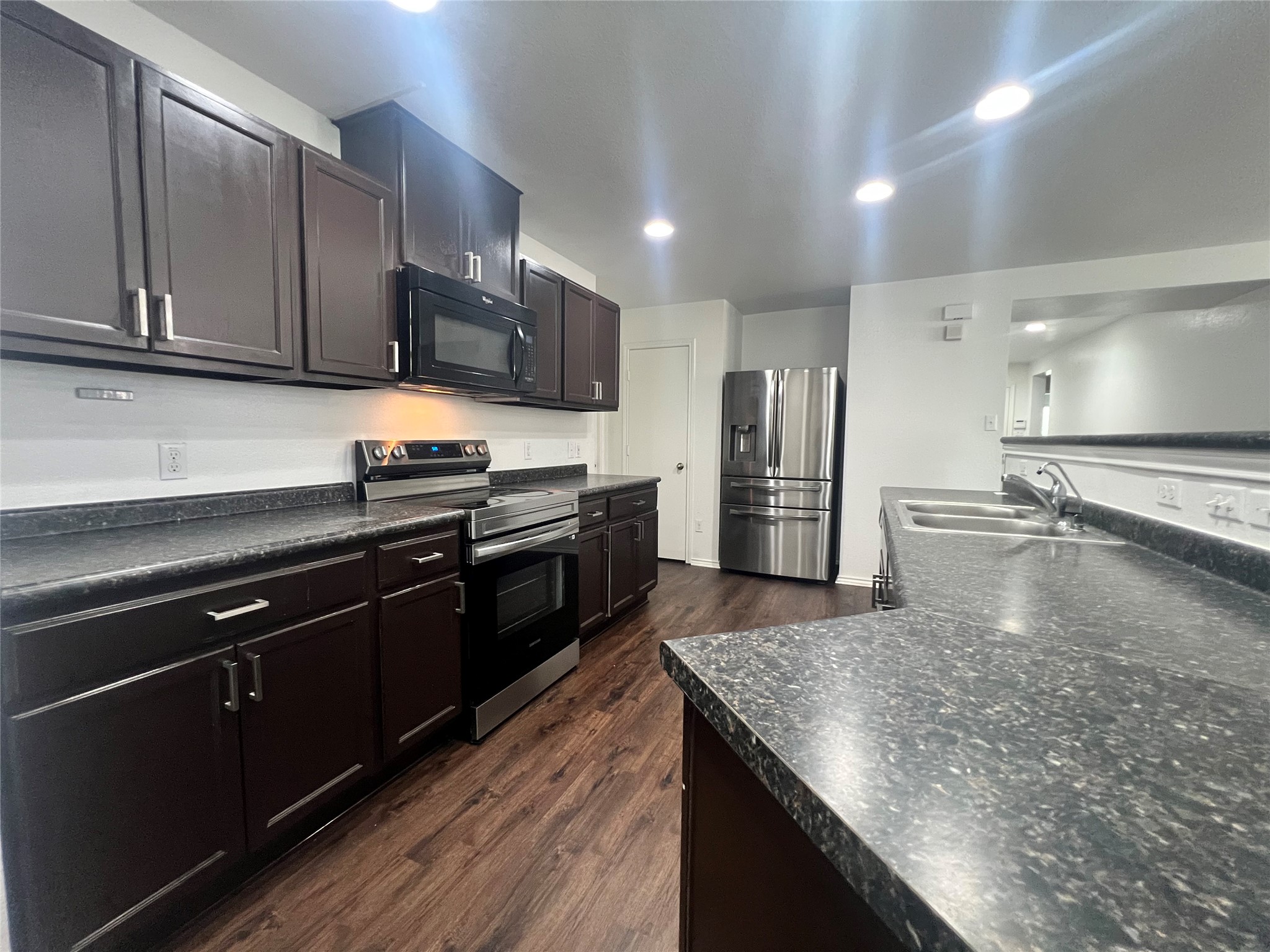 270 Sheep Trail Drive Kyle, TX 78640 - Photo 13 of 27 a large kitchen with stainless steel appliances and a counter space