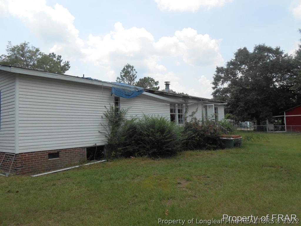 212 Grummen Road Hope Mills, NC 28348 - Photo 2 of 2 a view of a backyard with plants and a large tree