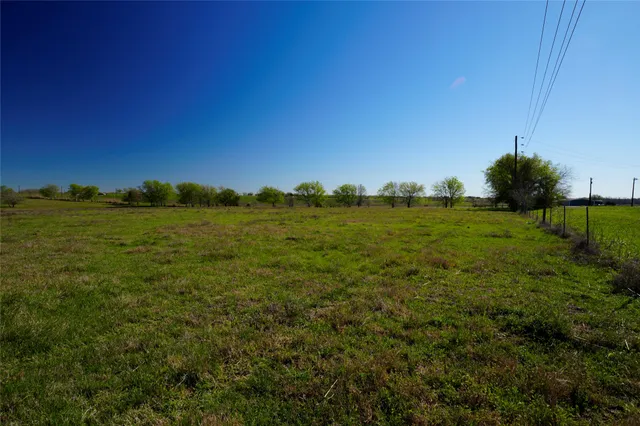 a view of a field with an ocean