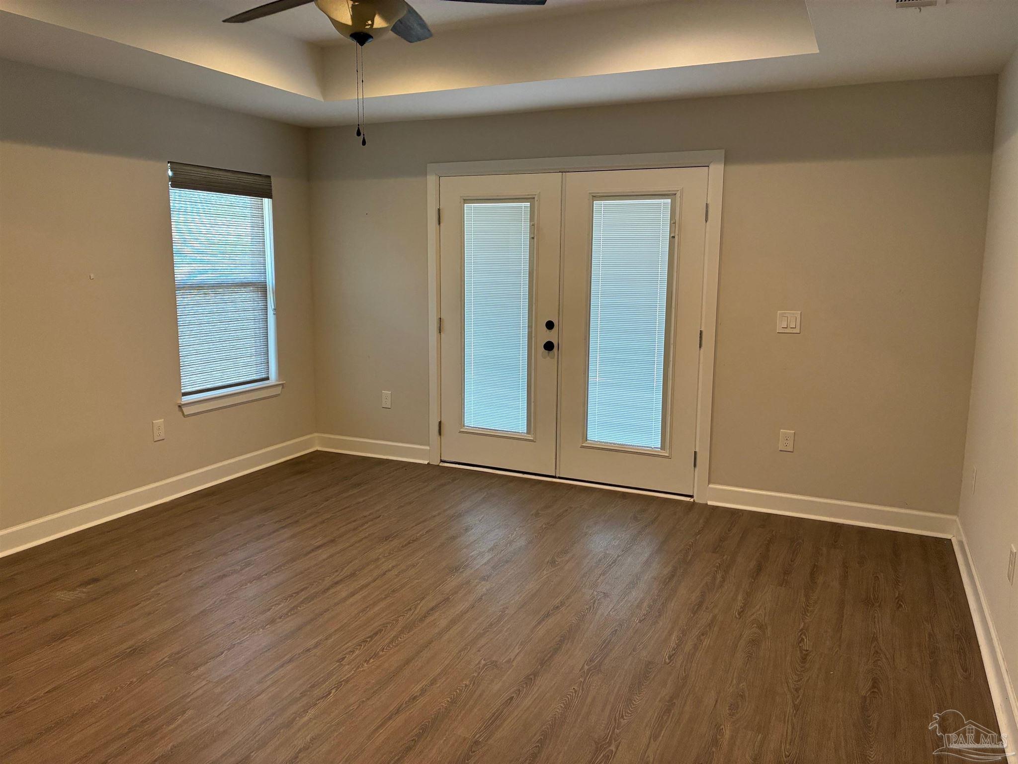 4090 Manchester Court Pace, FL 32571 - Photo 11 of 33 a view of an empty room with wooden floor and a window