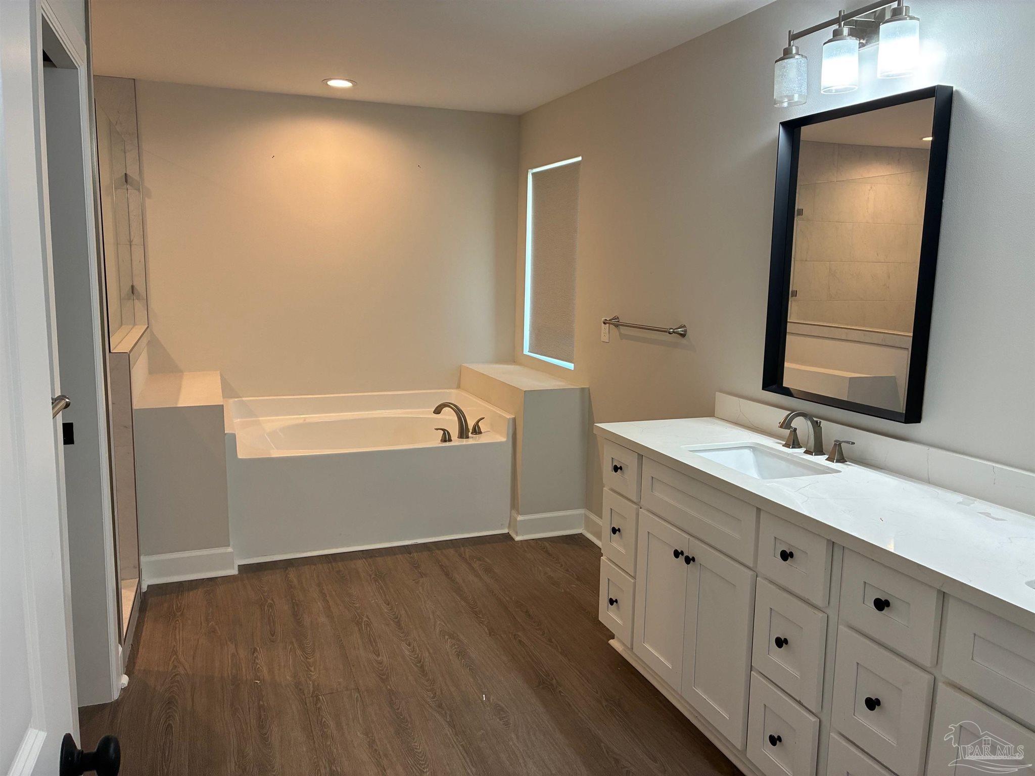 4090 Manchester Court Pace, FL 32571 - Photo 12 of 33 a bathroom with a double vanity sink and a mirror