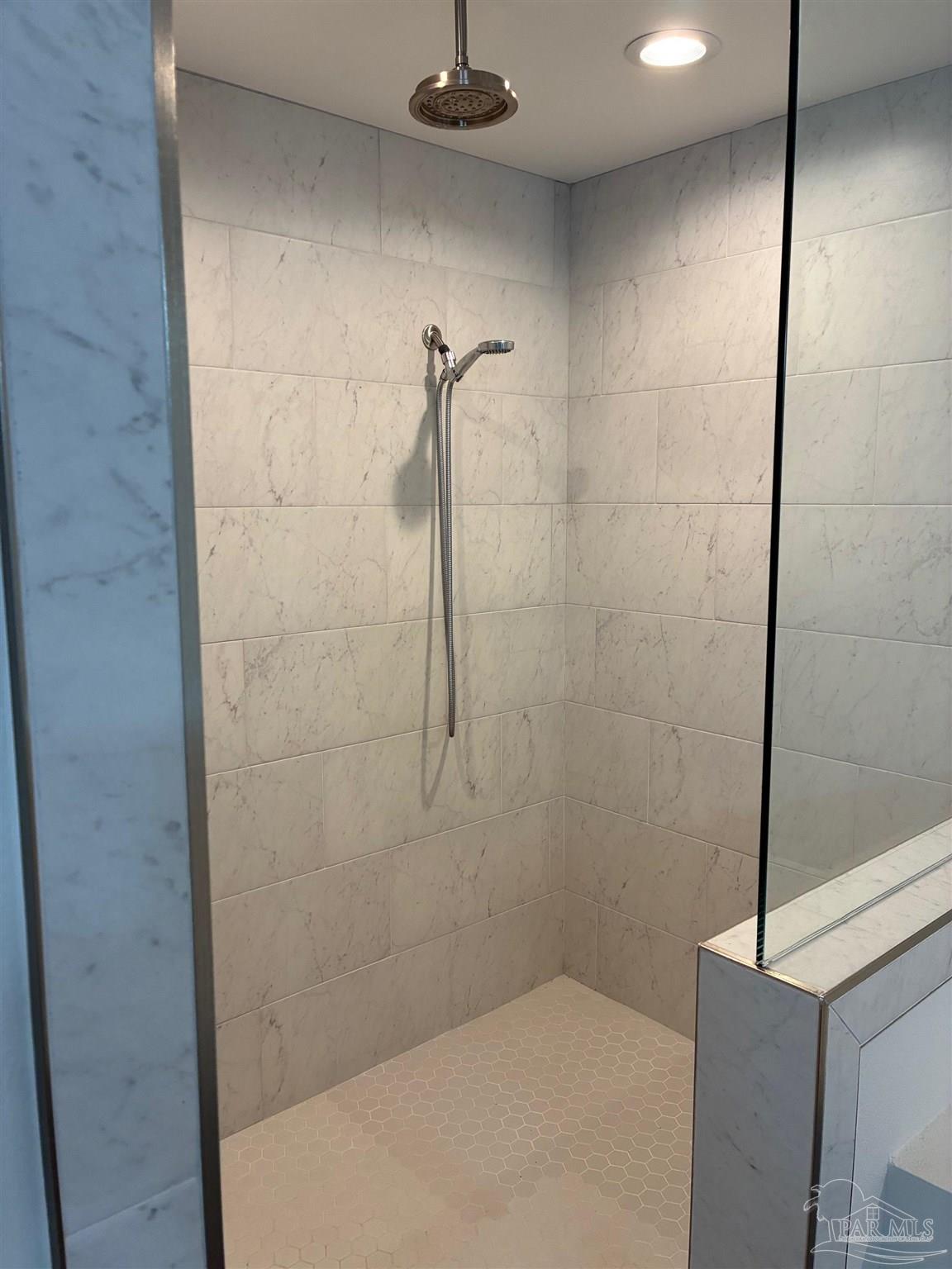 4090 Manchester Court Pace, FL 32571 - Photo 13 of 33 a bathroom with a shower and a tiled wall