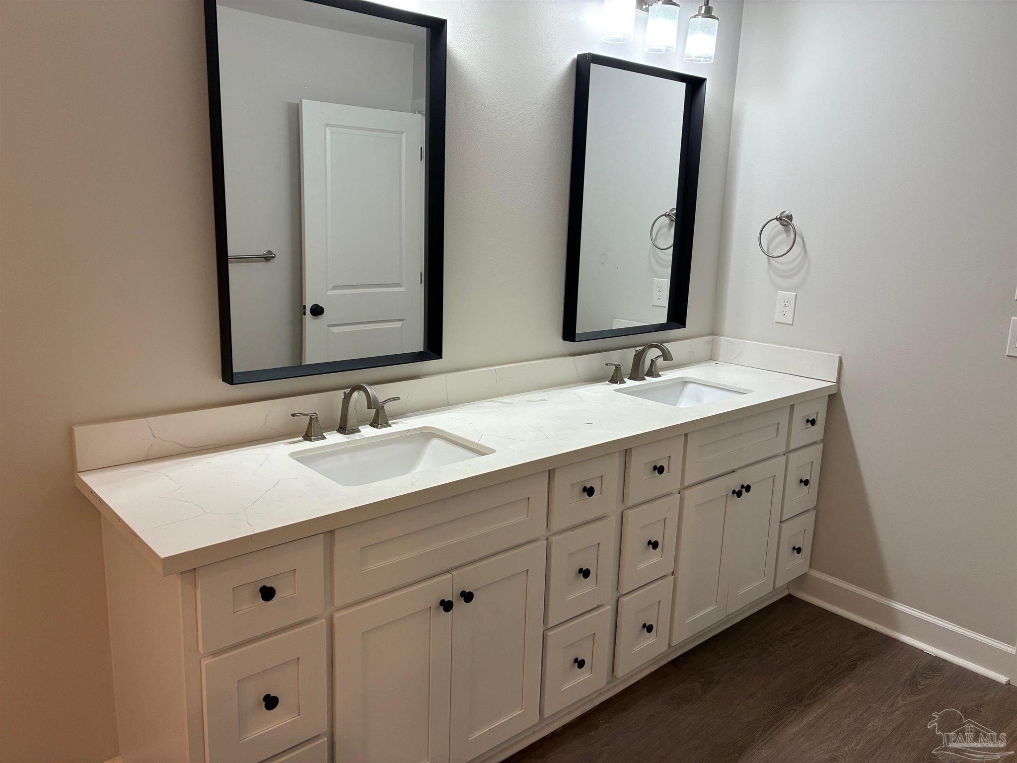 4090 Manchester Court Pace, FL 32571 - Photo 14 of 33 a bathroom with double vanity sink two mirror and a window
