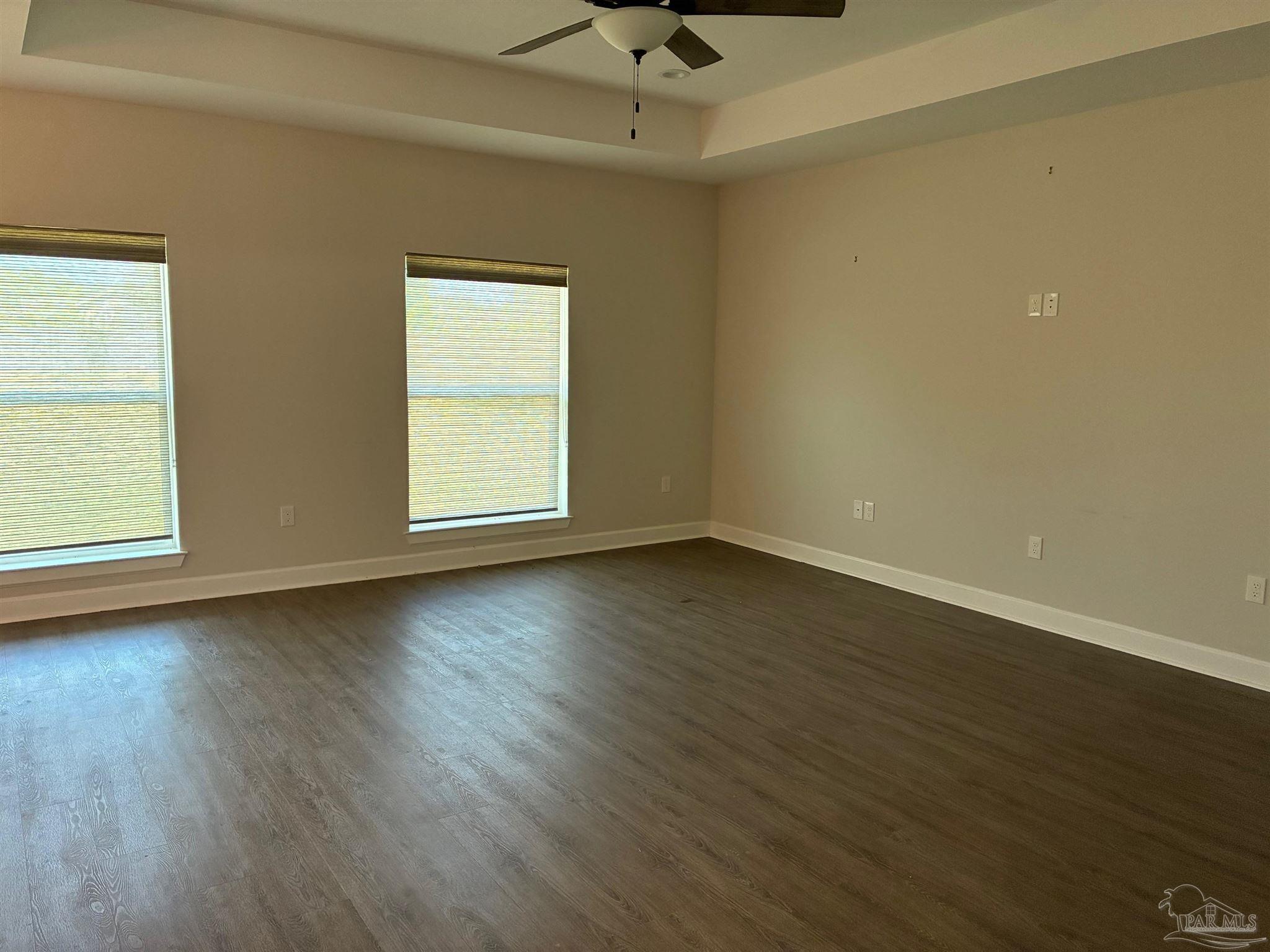 4090 Manchester Court Pace, FL 32571 - Photo 16 of 33 an empty room with wooden floor and windows