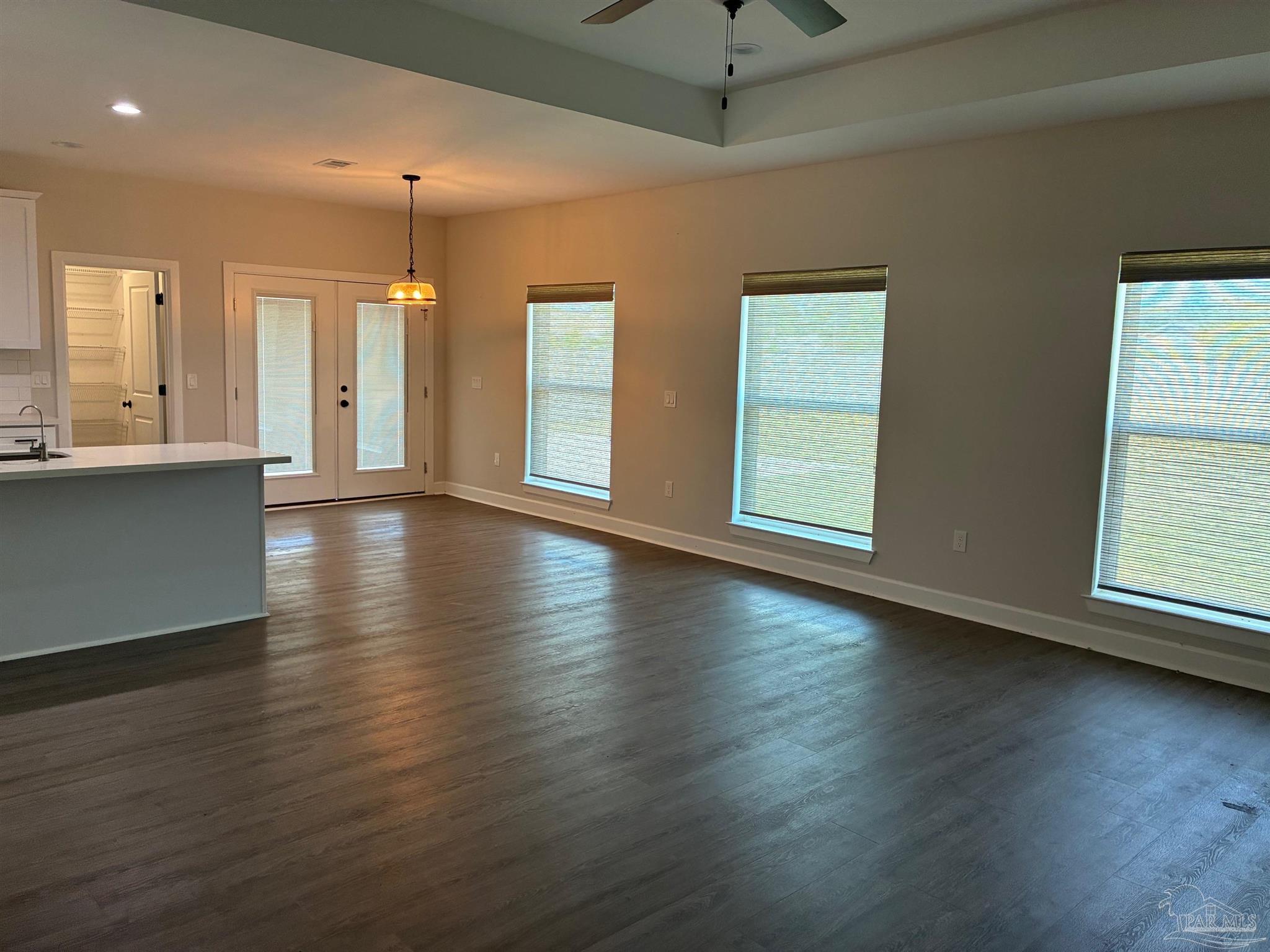 4090 Manchester Court Pace, FL 32571 - Photo 17 of 33 an empty room with wooden floor and windows