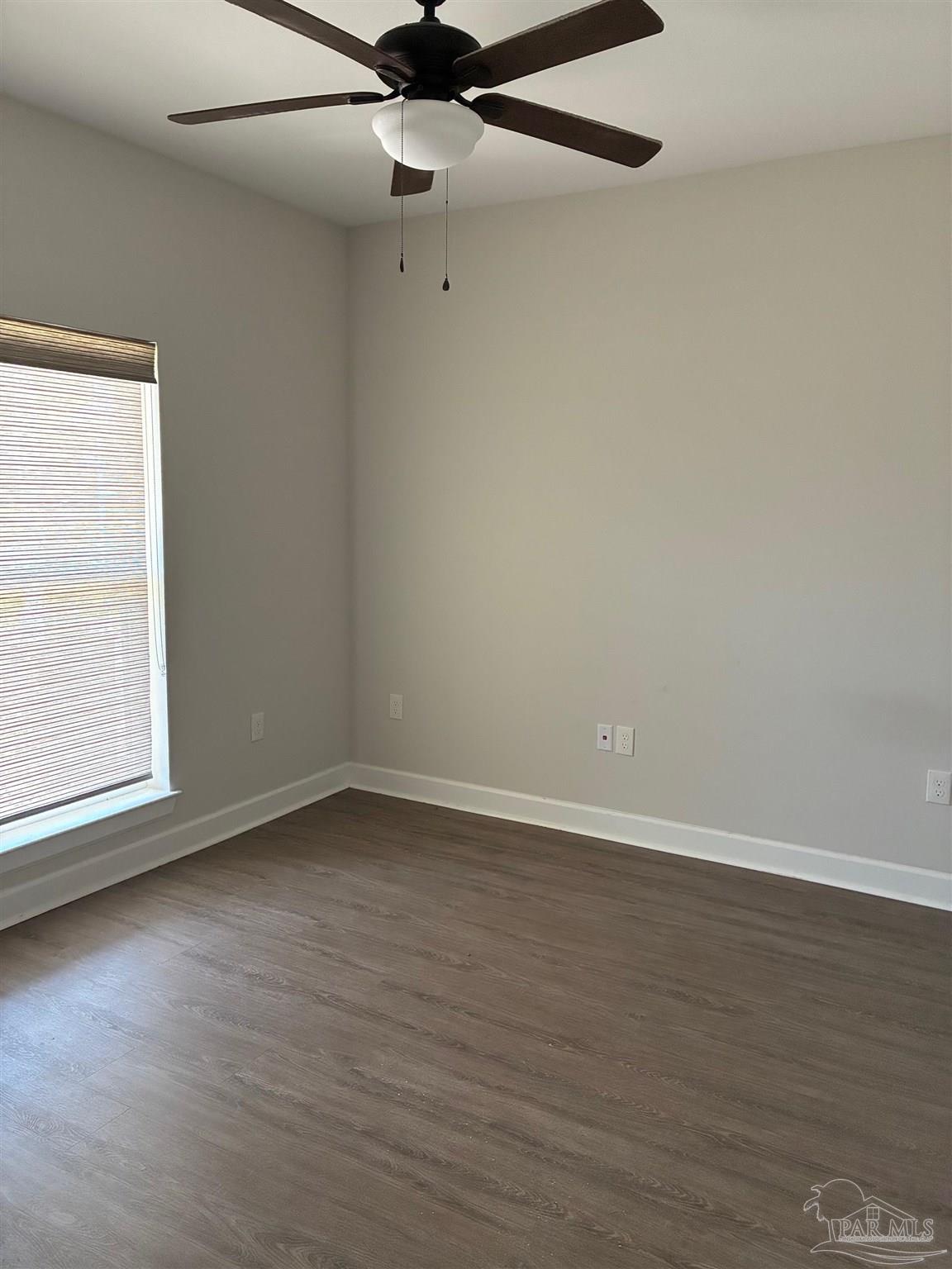 4090 Manchester Court Pace, FL 32571 - Photo 20 of 33 an empty room with wooden floor and windows