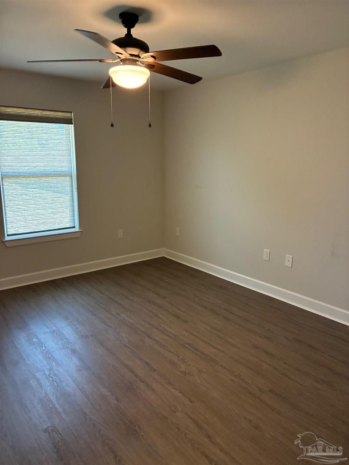 4090 Manchester Court Pace, FL 32571 - Photo 21 of 33 a big room with wooden floor chandelier fan and windows