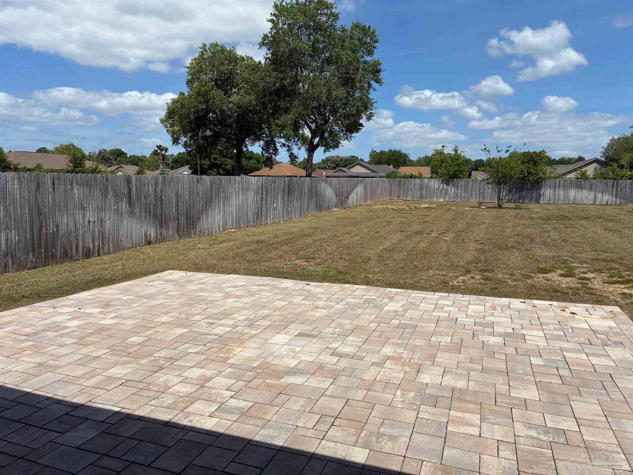 4090 Manchester Court Pace, FL 32571 - Photo 23 of 33 a backyard of a house with lots of green space and lake view