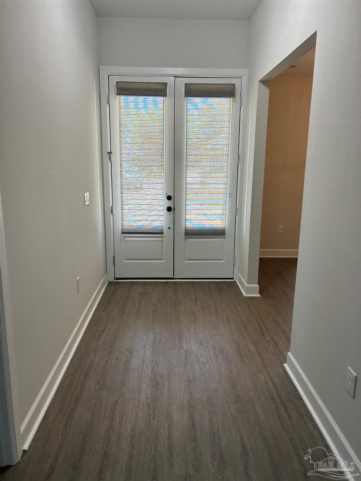 4090 Manchester Court Pace, FL 32571 - Photo 27 of 33 an empty room with wooden floor and windows