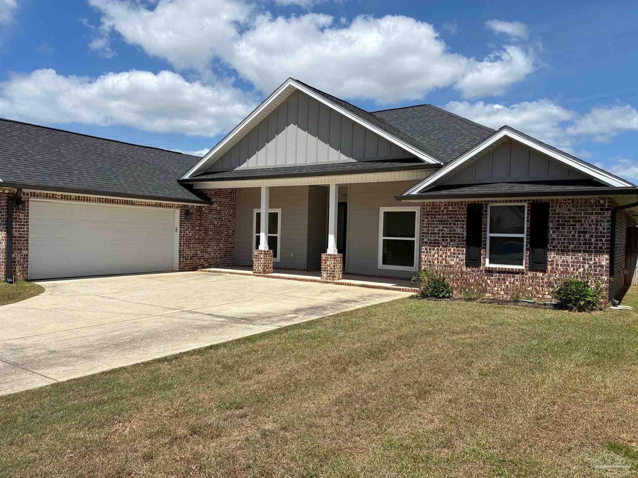 4090 Manchester Court Pace, FL 32571 - Photo 28 of 33 a front view of a house with a yard and garage