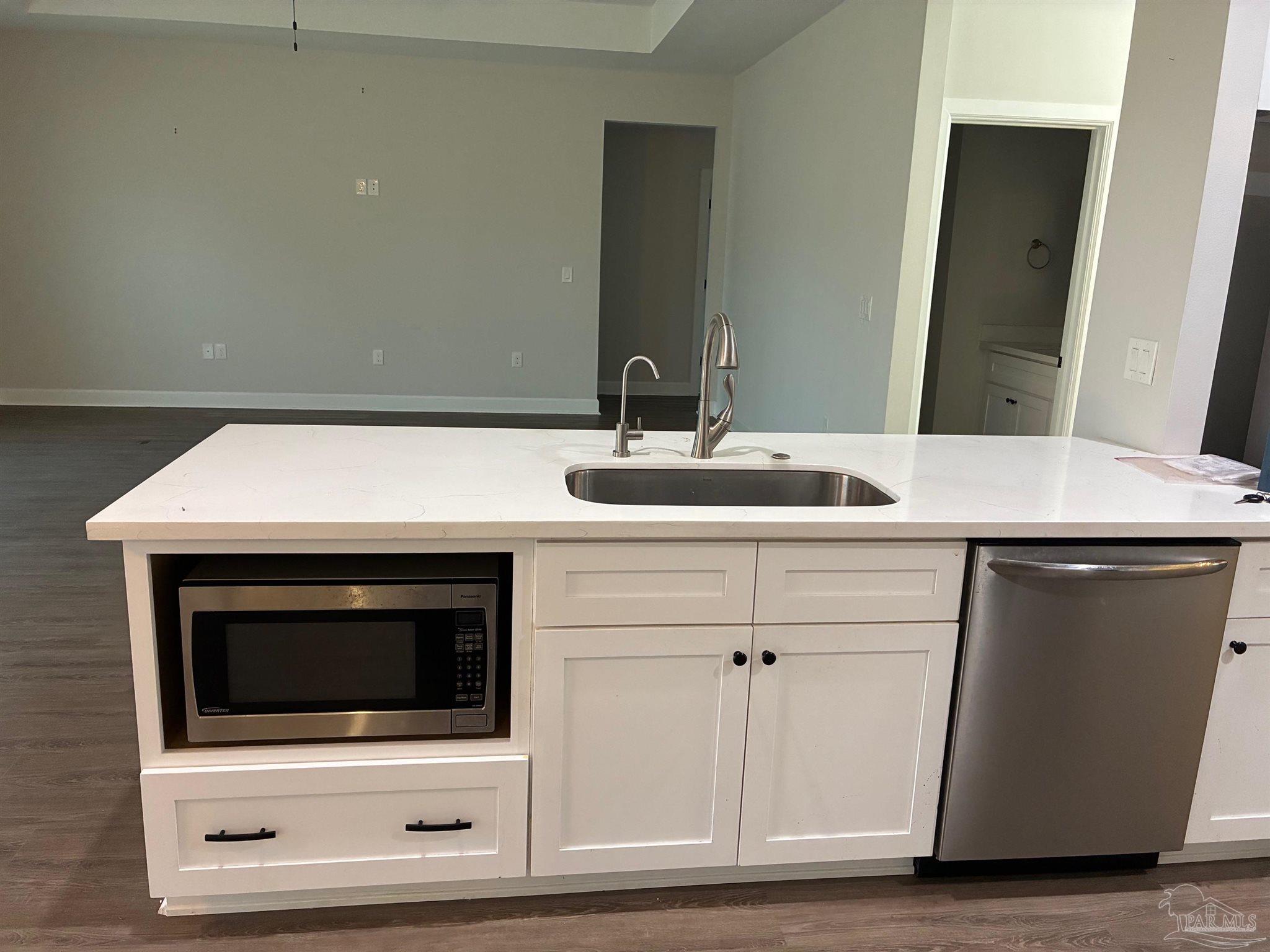 4090 Manchester Court Pace, FL 32571 - Photo 5 of 33 a bathroom with a sink and a microwave