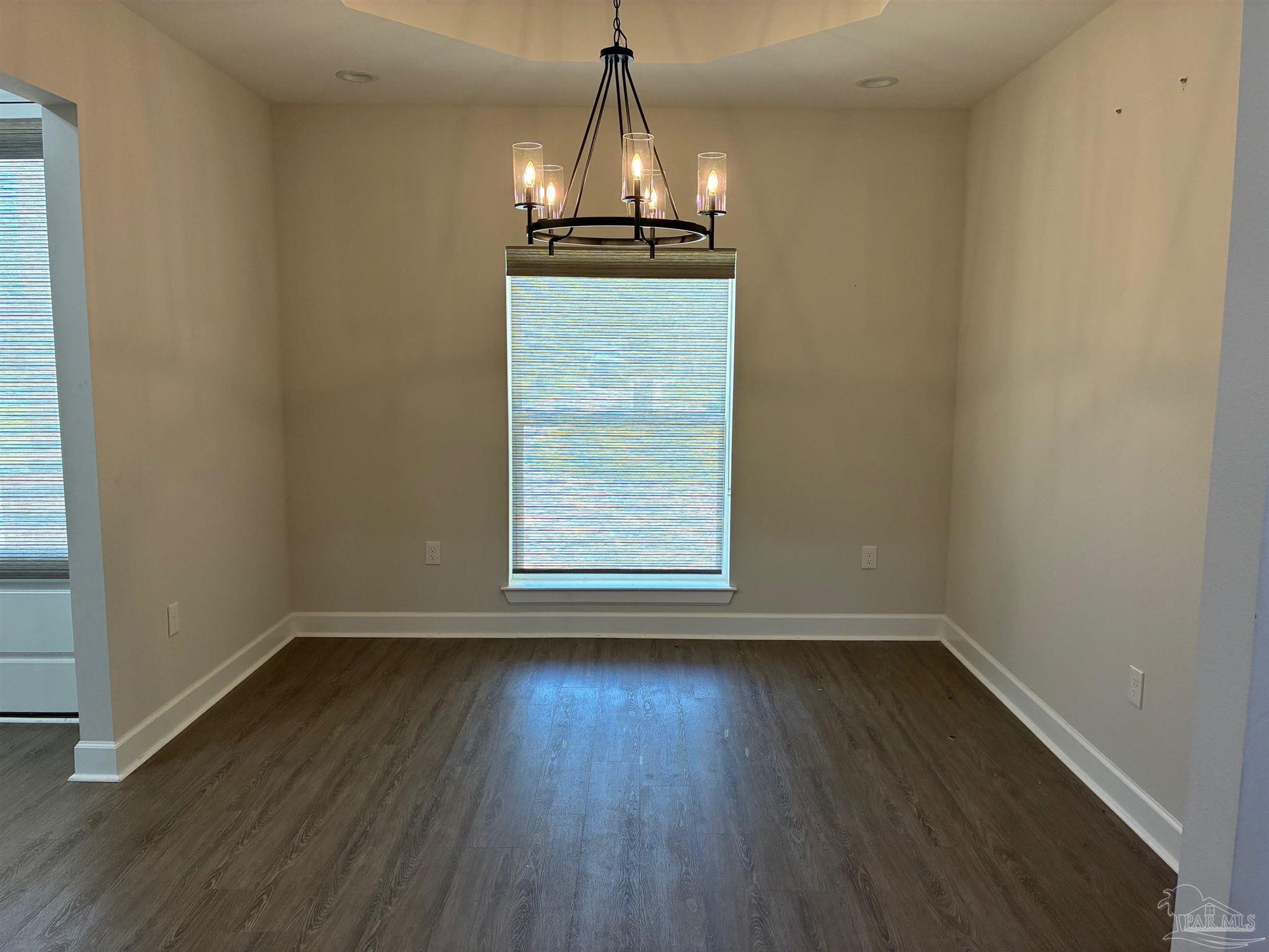 4090 Manchester Court Pace, FL 32571 - Photo 9 of 33 a view of a room with wooden floor air conditioner and a window