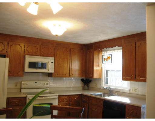 12 Lowry Road Framingham, MA 01701 - Photo 5 of 12 a kitchen with granite countertop a stove a sink and a microwave
