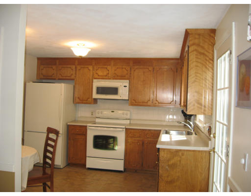 12 Lowry Road Framingham, MA 01701 - Photo 6 of 12 a kitchen with a stove and a microwave