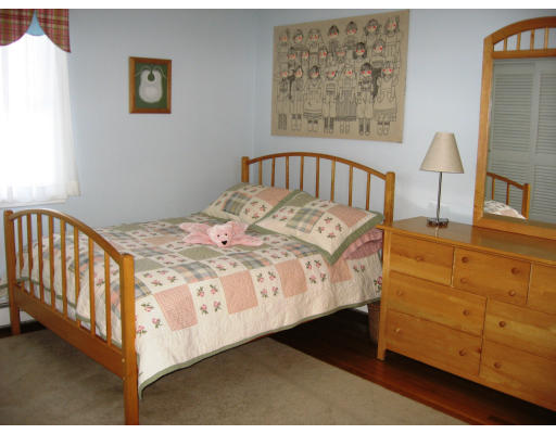 12 Lowry Road Framingham, MA 01701 - Photo 8 of 12 a bedroom with a bed and a painting on the wall