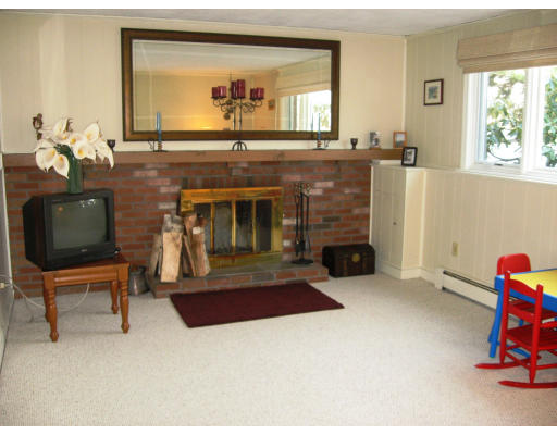12 Lowry Road Framingham, MA 01701 - Photo 9 of 12 a living room with furniture and a fireplace