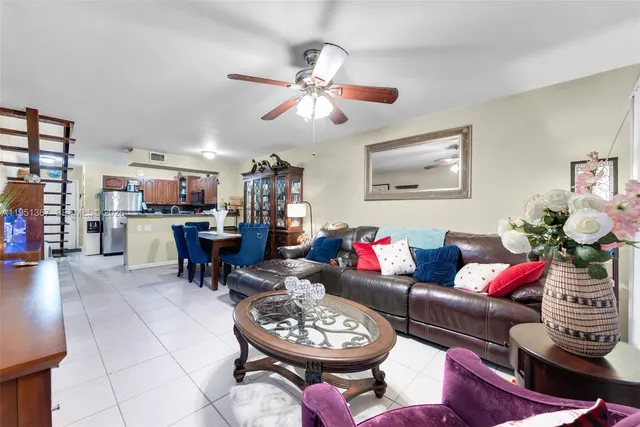 a living room with furniture a rug and a chandelier