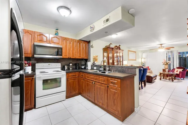 a kitchen with stainless steel appliances granite countertop a stove top oven a sink dishwasher and cabinets