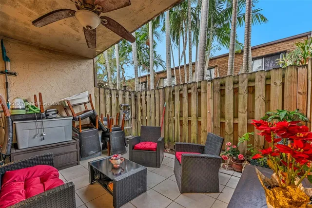 a living room with furniture and flowers