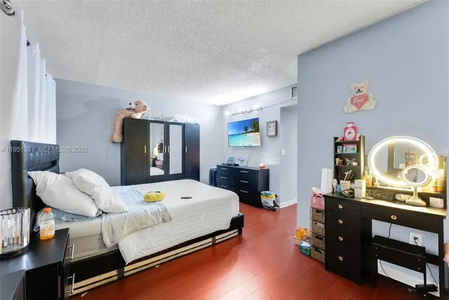 a bedroom with a bed and dresser