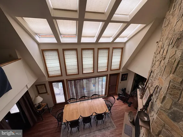 a living room with furniture a fireplace and a large window