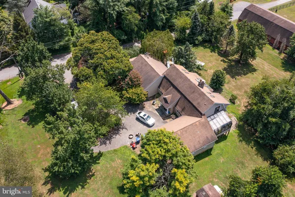 an aerial view of a house with yard swimming pool and outdoor seating