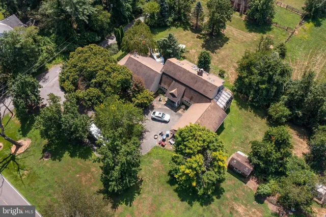 an aerial view of house with yard swimming pool and outdoor seating
