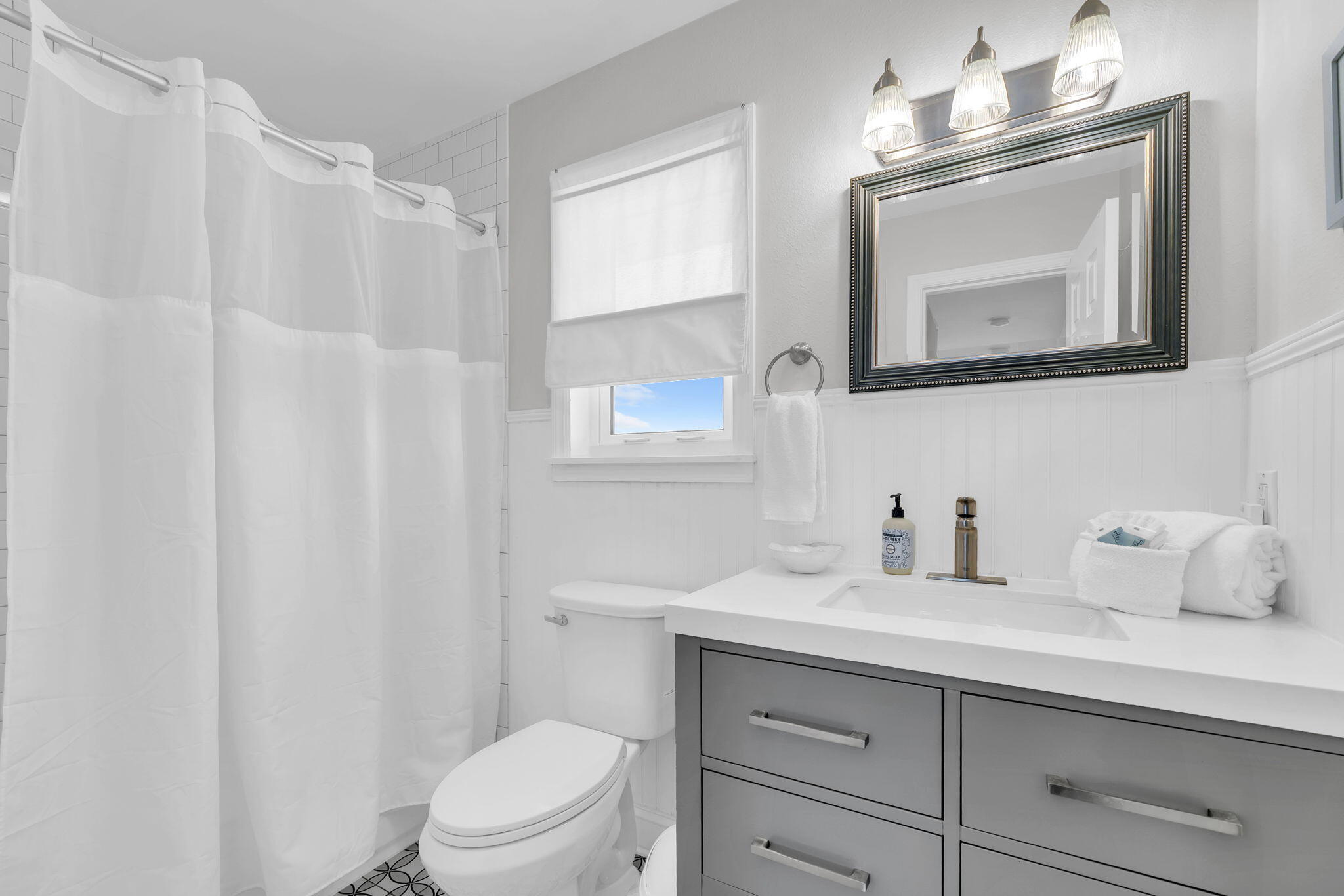 11 Beachside Drive, Unit 131 Santa Rosa Beach, FL 32459 - Photo 21 of 25 a bathroom with a toilet a sink a vanity a mirror and