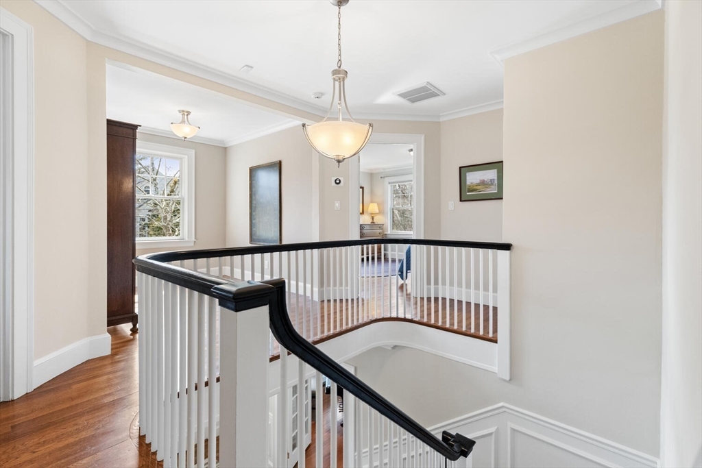 209 Waltham Street Lexington, MA 02421 - Photo 20 of 39 a view of a hallway with wooden floor and staircase