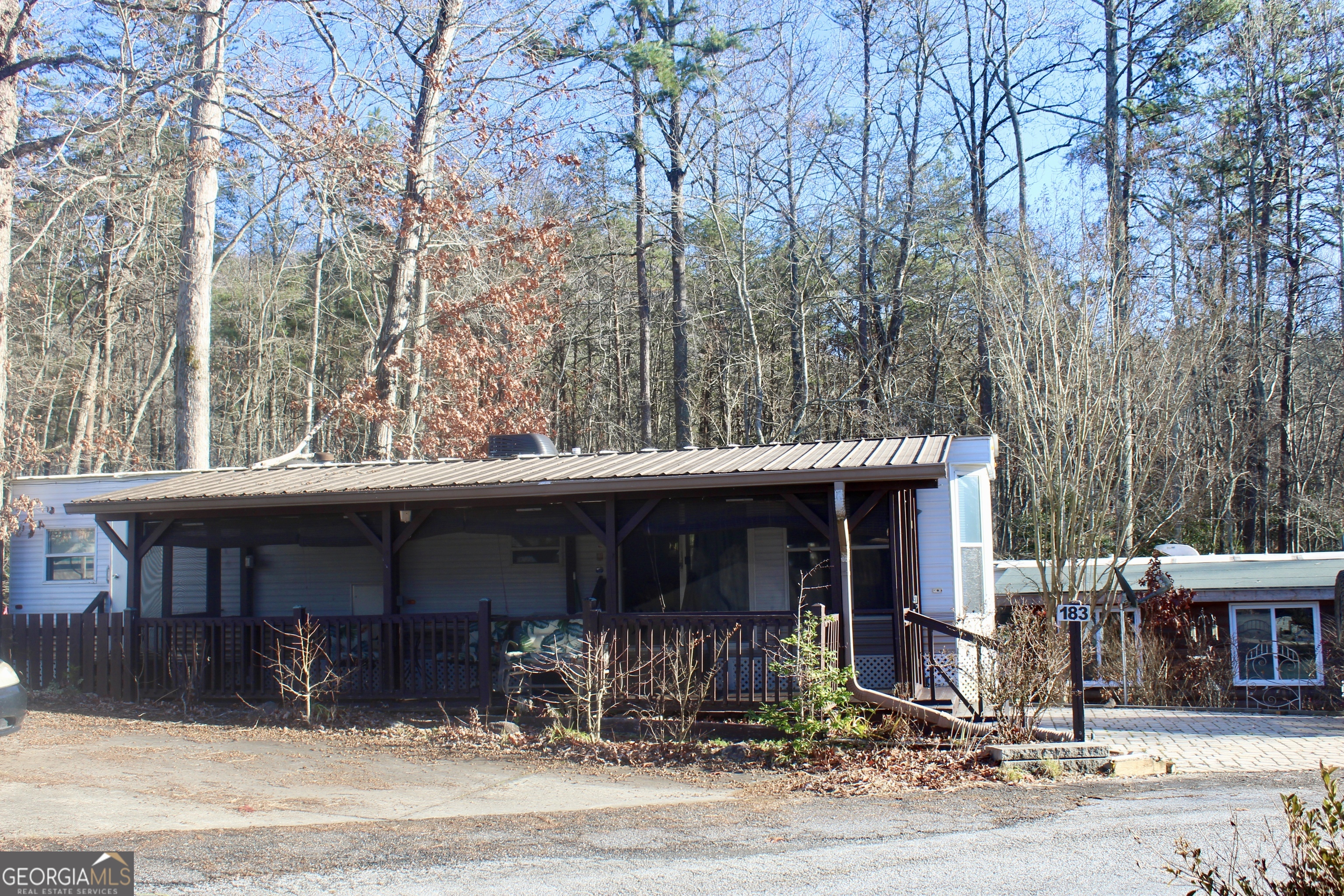 183 Holiday Loop Cleveland, GA 30528 - Photo 3 of 22 a front view of a house with yard outdoor seating and garage
