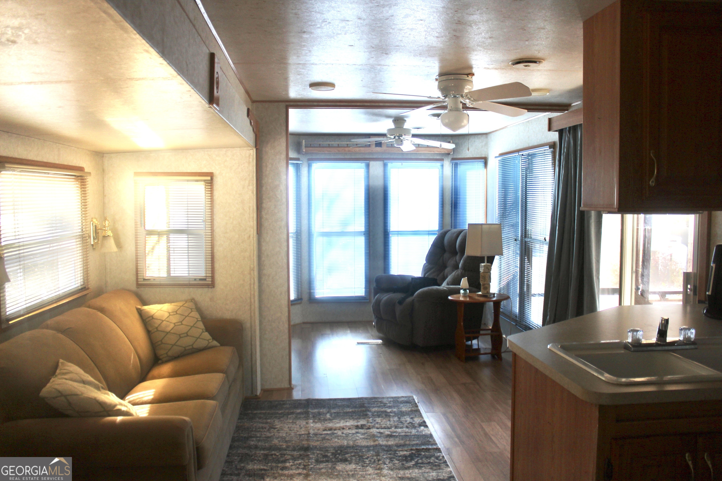 183 Holiday Loop Cleveland, GA 30528 - Photo 7 of 22 a living room with furniture and a chandelier