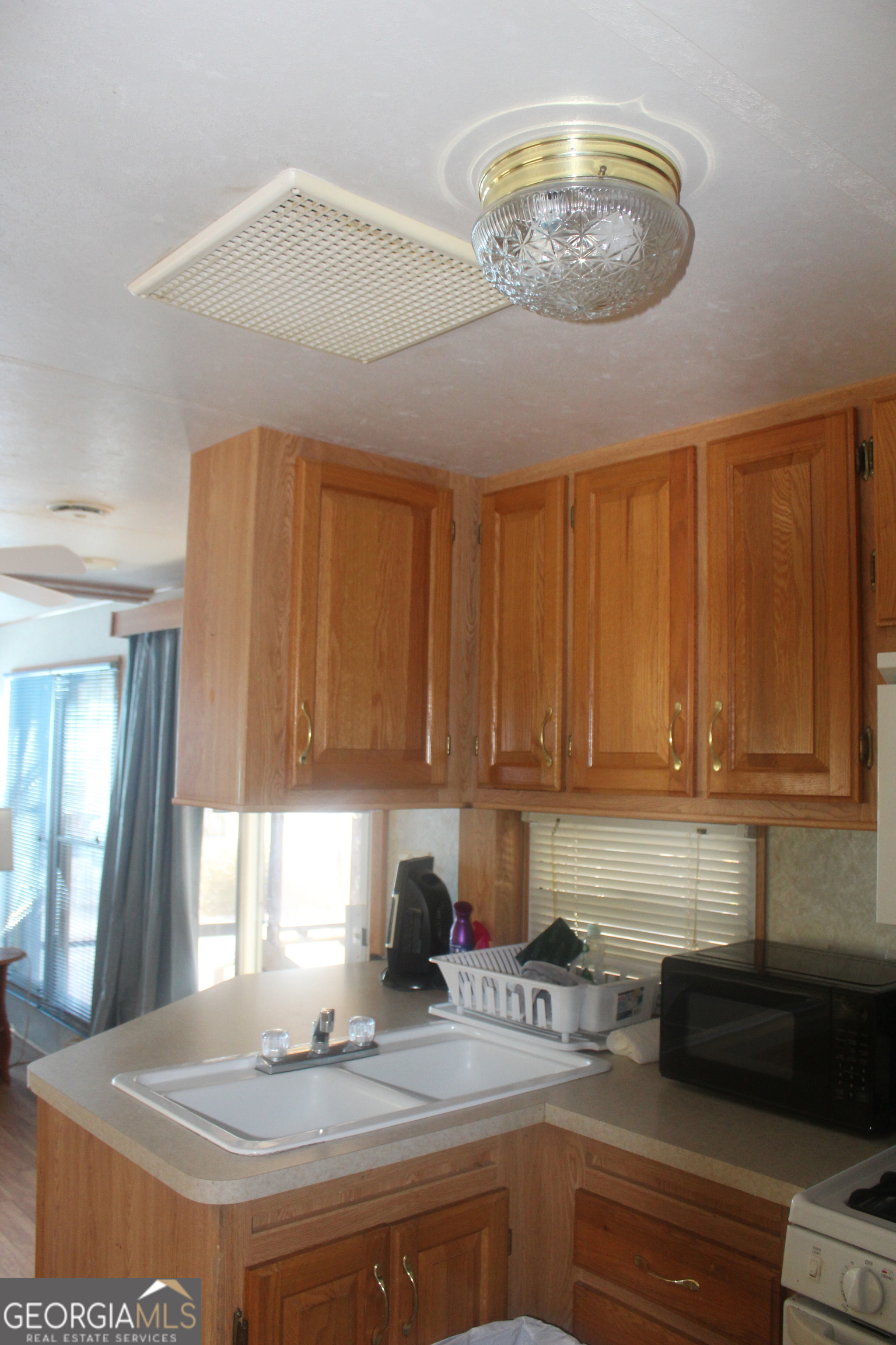 183 Holiday Loop Cleveland, GA 30528 - Photo 10 of 22 a kitchen with a stove and chandelier