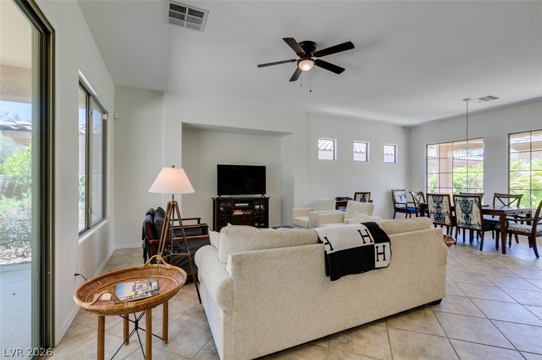 8 Kennesaw Road Henderson, NV 89052 - Photo 16 of 44 Seamlessly blending indoor comfort with outdoor views, this living space features high ceilings and a tiled floor.