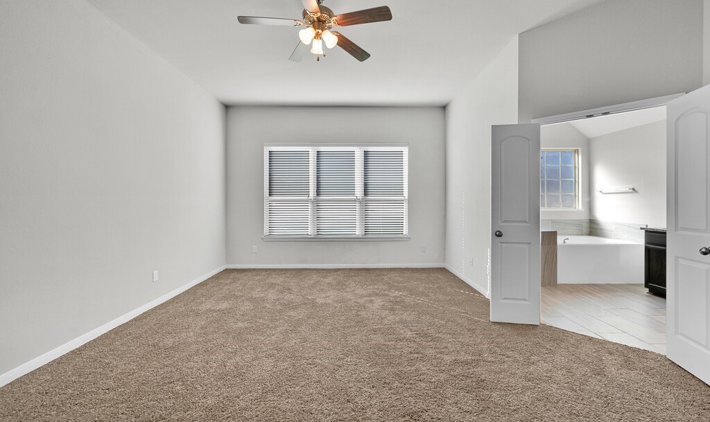 10624 Langham Drive Waco, TX 76708 - Photo 17 of 40 an empty room with windows and cabinet