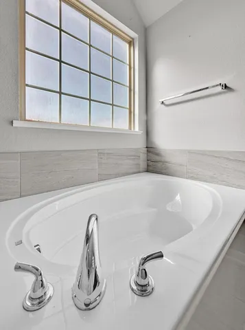 a bath tub sitting next to a window