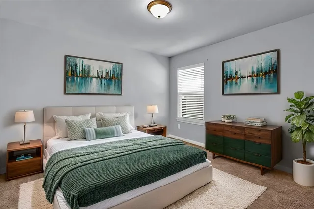 a bedroom with a bed and a workspace