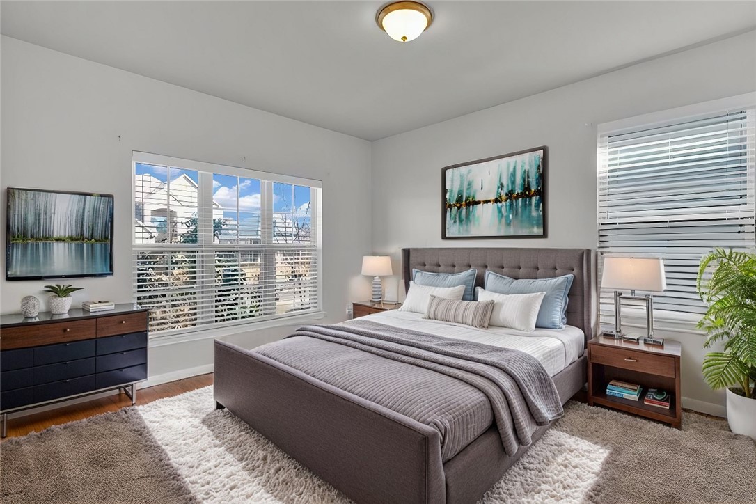 10624 Langham Drive Waco, TX 76708 - Photo 29 of 40 a bedroom with a large bed and a flat tv screen on dresser