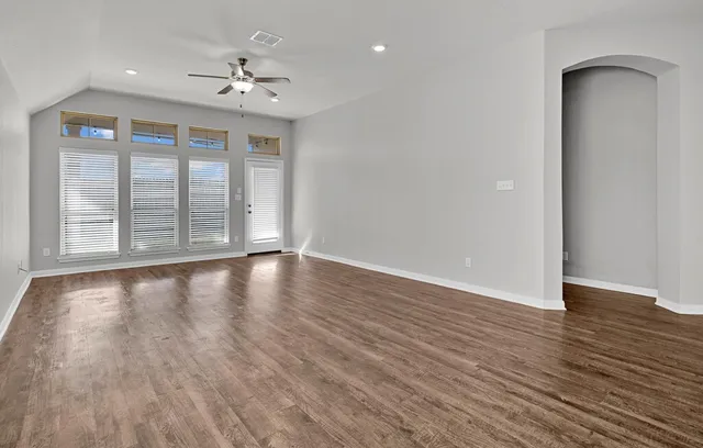 wooden floor in an empty room with a window