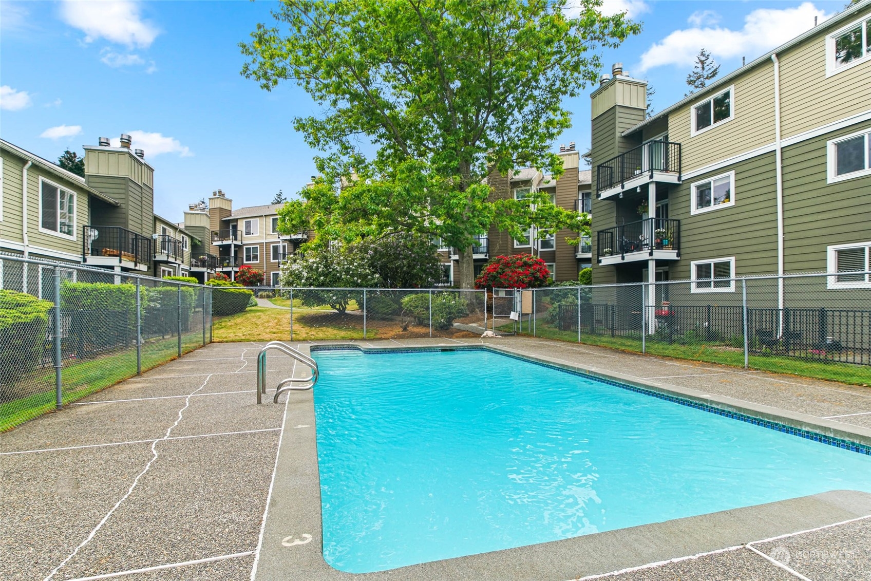 820 Cady Road, Unit A305 Everett, WA 98203 - Photo 17 of 26 a view of a swimming pool with a lounge chairs